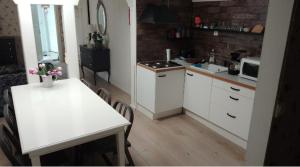 a kitchen with a table and a white counter top at Villa VINCENT in Naantali