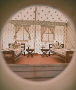 Habitación con 2 camas y 2 ventanas. en Shivadya Camps MAHAKUMBH Mela, en Allahābād