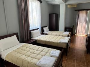 Postelja oz. postelje v sobi nastanitve SIRENA HOTEL