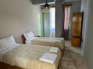Postelja oz. postelje v sobi nastanitve SIRENA HOTEL