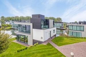 an aerial view of a house with a river at Lake House with dock at Lake Veere, Zeeland in Arnemuiden
