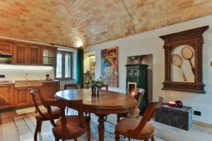 a kitchen with a wooden table and chairs at Relais Scanno Red Home in Scanno