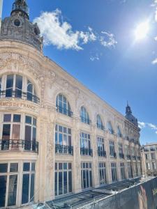 a large building with the sun in the sky at Domus Via Domitia in Narbonne