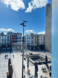 a view of a city square with buildings and people at Domus Via Domitia in Narbonne