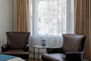 two chairs and a table in front of a window at Highbrook Motel in Bar Harbor