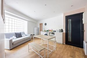 a living room with a couch and a table at Charme Parisien 6 Personnes, 2 chambres, 19ème in Paris