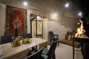 a living room with a table and a fireplace at View Cave Hotel in Göreme