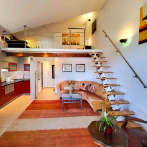 a living room with a couch and a staircase at Ferienwohnungen Velijoze in Poreč