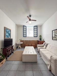 a living room with a couch and a ceiling fan at Casa Vix - Centro Histórico in Vitória