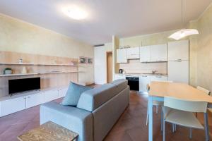 a living room with a couch and a table at Appartamento Gardazzurro in Padenghe sul Garda