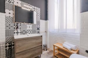 een badkamer met een wastafel en een spiegel bij Panurban Rooms by Wonderful Italy in Palermo +26 foto's
