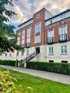 a large brick building with a sidewalk in front of it at This weekend! Two double rooms with parking in quiet well-kept flat in Hatfield