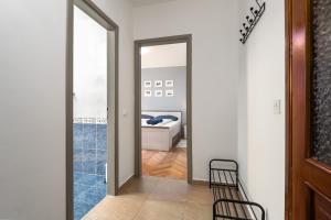 a hallway with a mirror and a bed in a room at Blue Apartment in Vrsar