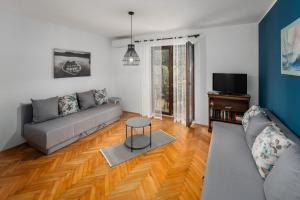 a living room with a couch and a table at Blue Apartment in Vrsar