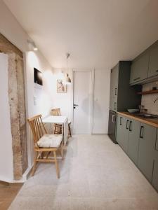 a kitchen with a table and chairs in a room at Casa Myrilla in Corfu