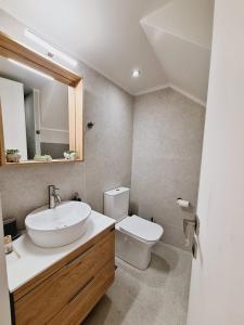 a bathroom with a sink and a toilet at Casa Myrilla in Corfu +8 photos