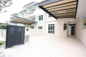 a view of a house with awning and a patio at Shamrock Beach Villas 9 Seaview in George Town