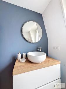 a bathroom with a white sink and a mirror at Élégance Malouine - 500m Plage in Dunkerque +25 photos