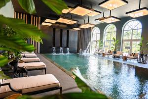 a pool with lounge chairs and a swimming pool at Amoure Hotel - The Leading Hotels of the World in Braga