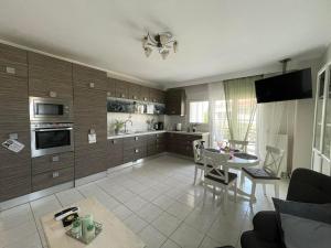 a kitchen with a table and a dining room at La Famiglia Appartment in Perea