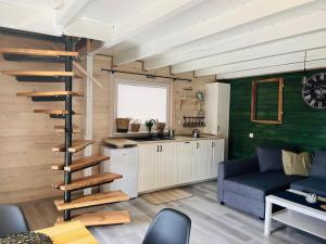 a living room with a spiral staircase in a tiny house at Domki przy Wesołej in Wiele