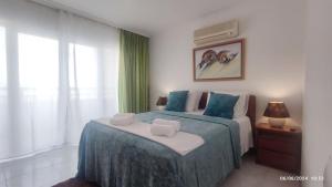 a bedroom with a bed with blue and white at Casa Jardins da Rocha in Portimão +23 photos