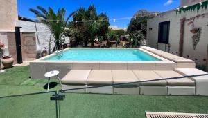 a large swimming pool in a yard with grass at Ricordi Siciliani - Charme Rooms in San Vito lo Capo