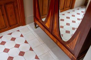 a bathroom with a tiled floor and a mirror at La Novieta Boutique Hotel - Adults Only in Valencia