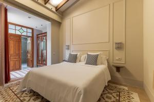 a bedroom with a large white bed in a room at La Novieta Boutique Hotel - Adults Only in Valencia