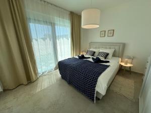 a bedroom with a bed and a large window at Lemon Navy house in Vodice +25 photos