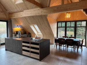 a kitchen and dining room with a table and chairs at Ferienwohnung in den Dorfwiesen in Gersfeld