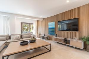 a living room with a large flat screen tv at Vila Hibisco by Garvetur in Vilamoura