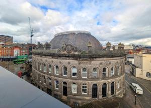an old building with a dome in a city at The Bells - Luxury Serviced Apartments in Leeds