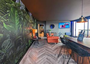 uma sala de estar com um grande mural de plantas na parede em The Bells - Luxury Serviced Apartments em Leeds