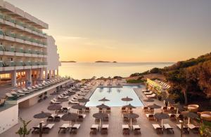 an overhead view of a hotel with a pool with chairs and umbrellas at Melia Ibiza - Adults Only in Santa Eularia des Riu