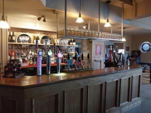 a bar with a lot of bottles of alcohol at Ye Olde Fighting Cocks in Arnside