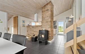 a living room with a fireplace and a stove at Four-Bedroom Holiday Home In Hvide Sande in Bjerregård