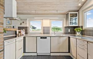 a kitchen with a sink and a dishwasher at Four-Bedroom Holiday Home In Hvide Sande in Bjerregård