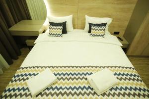 Postel nebo postele na pokoji v ubytování 4Guest Hotel