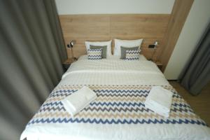 Postel nebo postele na pokoji v ubytování 4Guest Hotel
