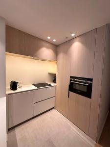 a kitchen with white cabinets and a stove top oven at Knokke Oasis Luxury Apartment in Centre in Knokke-Heist