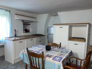a kitchen with a table with a table cloth on it at Apartment Kalikut in Beli