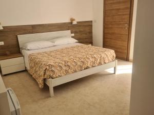 Säng eller sängar i ett rum på Lido Venere Case Vacanze
