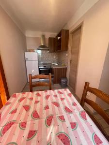 a kitchen with a table with a fruit pattern on it at Crveni apartman in Cres