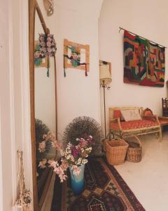 una stanza con specchio e vaso con fiori di Antica Dimora dei Nonni a Lecce