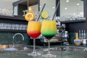 two glasses of colorful cocktails sitting on a counter at Hotel Monaco in Caorle