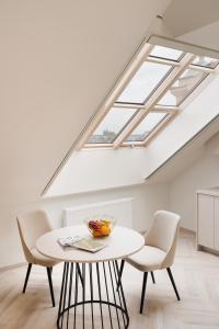 a skylight in a room with a table and chairs at NOBILIS RESIDENCE in Prague