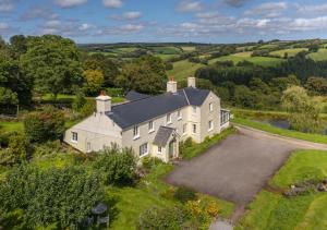 an aerial view of a large white house with a driveway at Stockham Farm, Dulverton in Dulverton