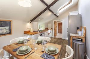 a kitchen and dining room with a wooden table and chairs at Stockham Farm, Dulverton in Dulverton