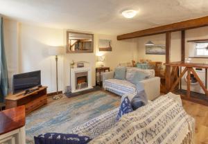 a living room with a couch and a fireplace at Cuain Cottage, Watchet in Watchet